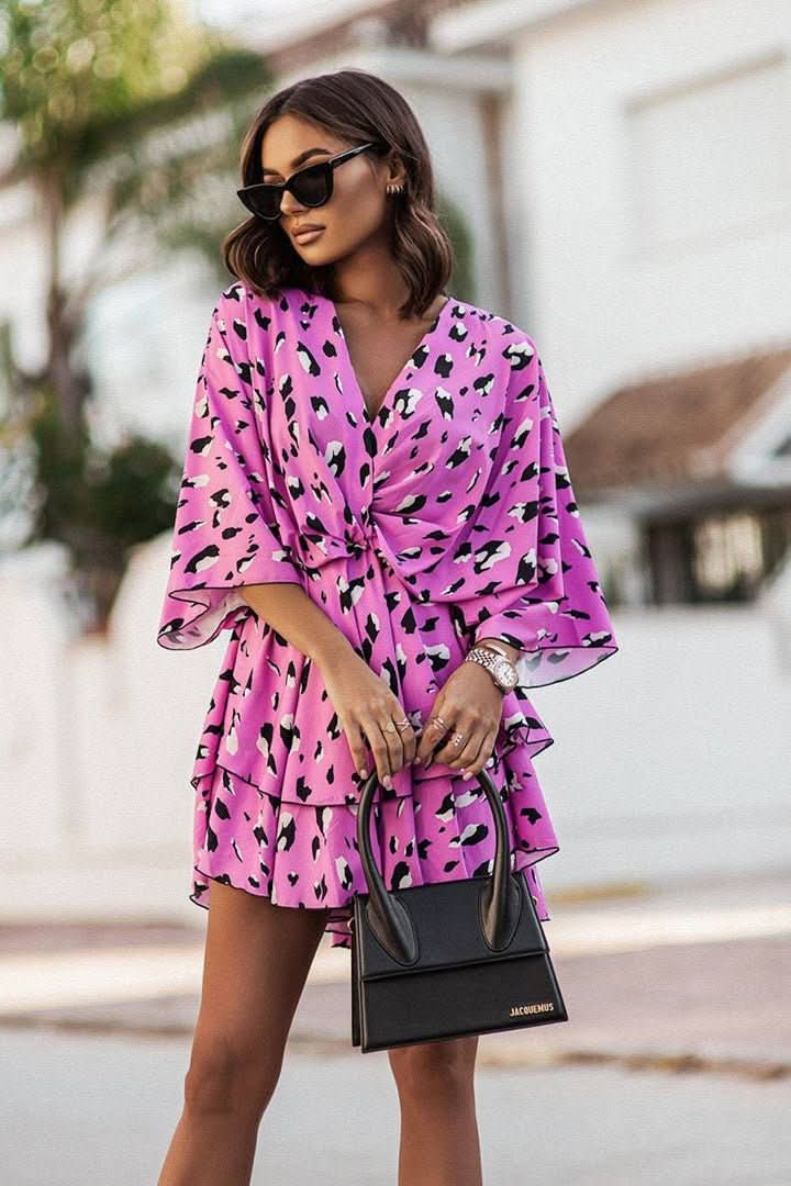 Trendy women's off-shoulder mini dress with a vibrant bohemian print, great for summer parties.