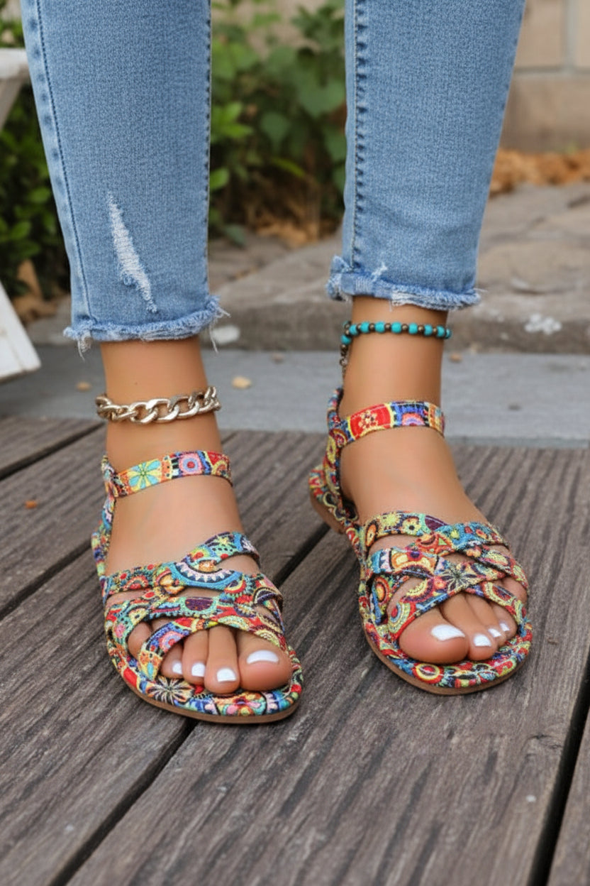 Elegant women's flat T-strap sandals featuring a beautiful Bohemian print, perfect for summer and vacation style.