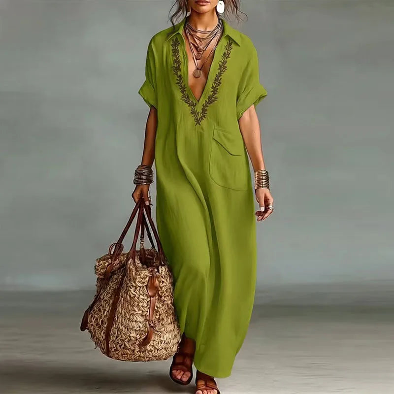 Vibrant bohemian printed maxi dress for women, featuring a deep V-neck & flowing short sleeves, great for summer.