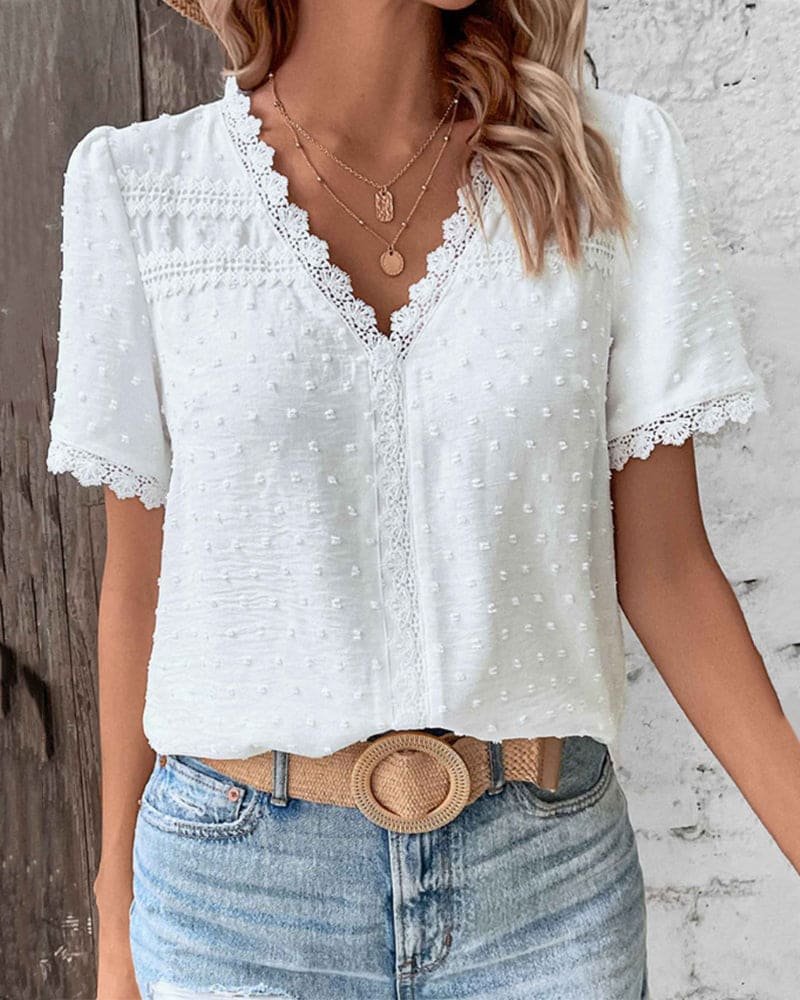 Women's bohemian Swiss dot V-neck top with delicate lace trim, perfect for spring/summer fashion.