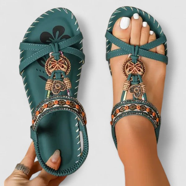 Stylish women's embroidered flat sandals with toe-ring detail, perfect for summer holidays.