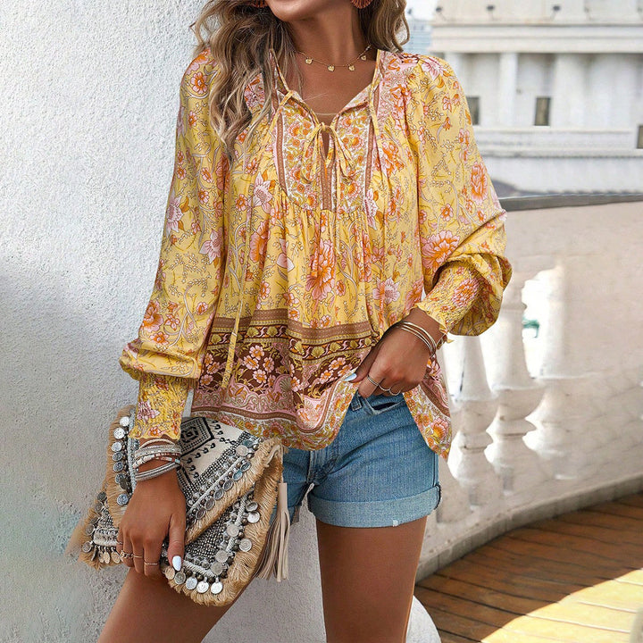 Chic women's loose boho floral blouse featuring puff sleeves & V-neck, offering comfortable spring fashion.