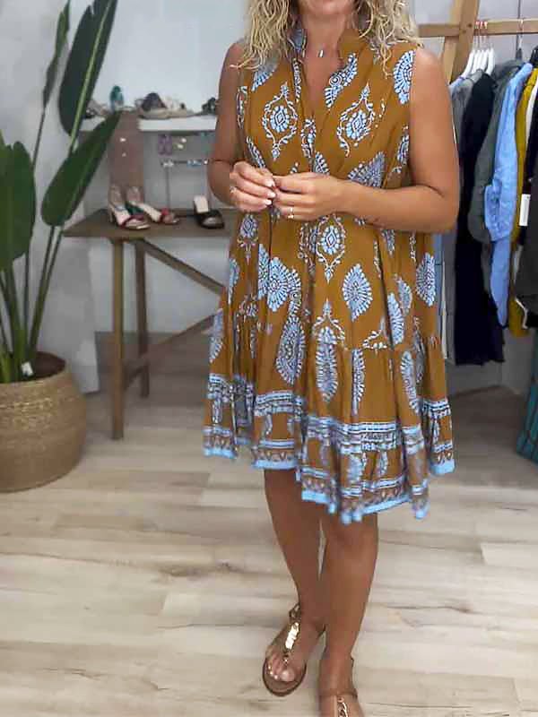 Sleeveless women's mini dress with a unique boho medallion print, smock style, and tiered ruffles for a comfortable, flowy fit.