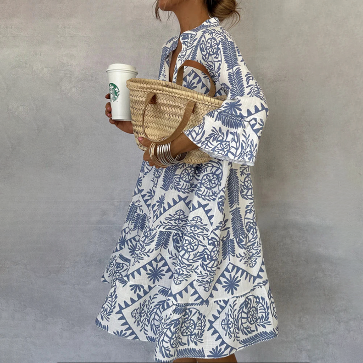 Women's boho print swing dress with V-neck, 3/4 sleeves. Perfect for summer casual wear or resort.