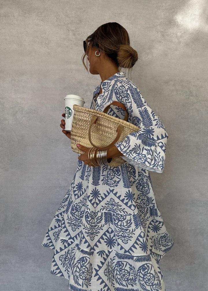 Casual women's swing dress with a vibrant boho print, V-neck, and practical 3/4 sleeves. Ideal day dress.