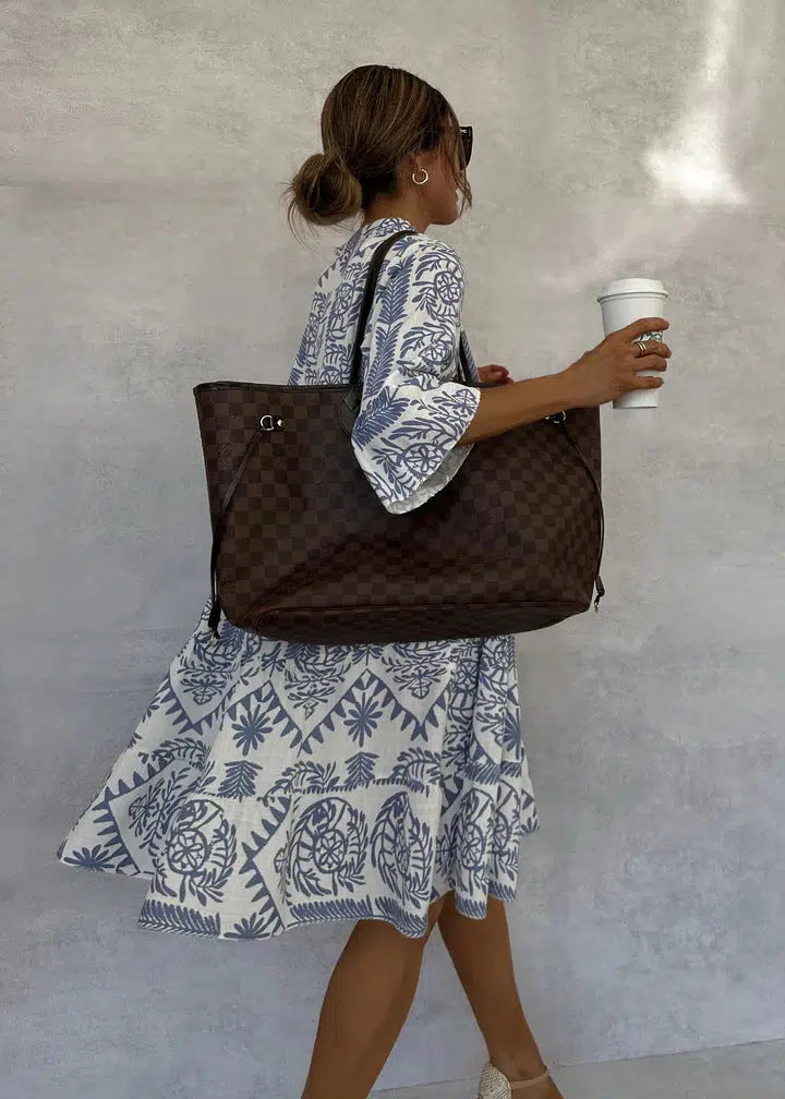 Stylish women's print dress; a loose-fitting boho swing style with V-neck, 3/4 sleeves for comfort.