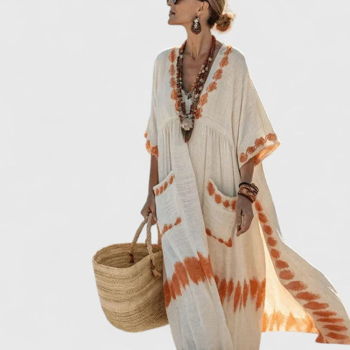 Stylish women's striped kaftan maxi dress with practical pockets, elegant V-neck, ideal for relaxed beach days.