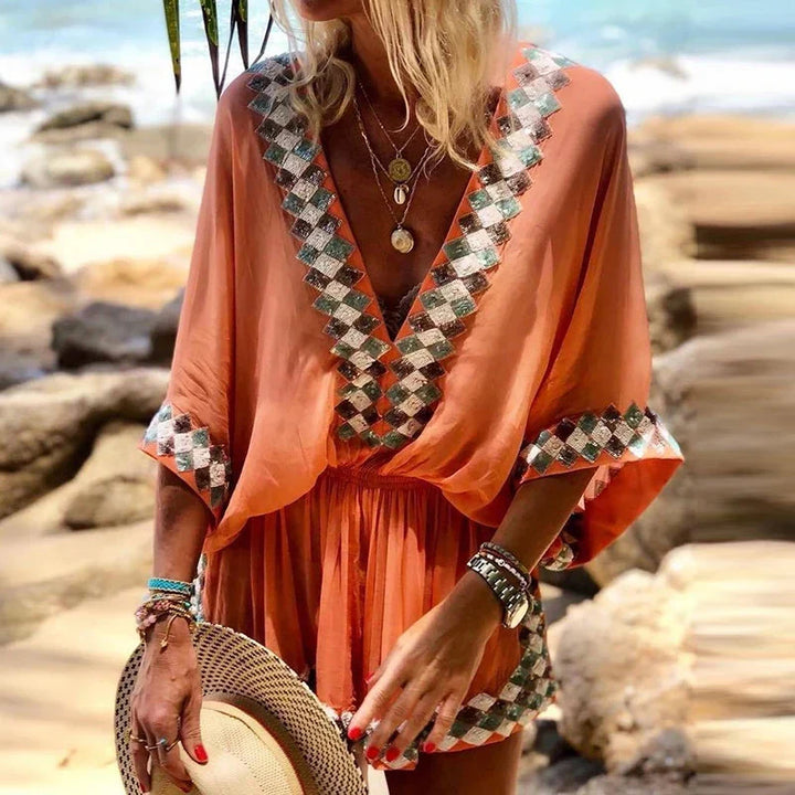 Trendy women's V-neck short jumpsuit in a boho style. Ideal for summer outfits, beachwear, or relaxed vacation looks.