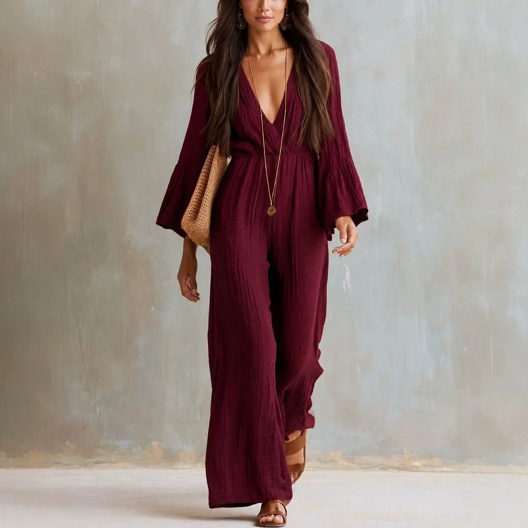 Flowy women's wide leg boho jumpsuit with deep V-neck, comfortable flare sleeves for summer fashion and brunch wear.