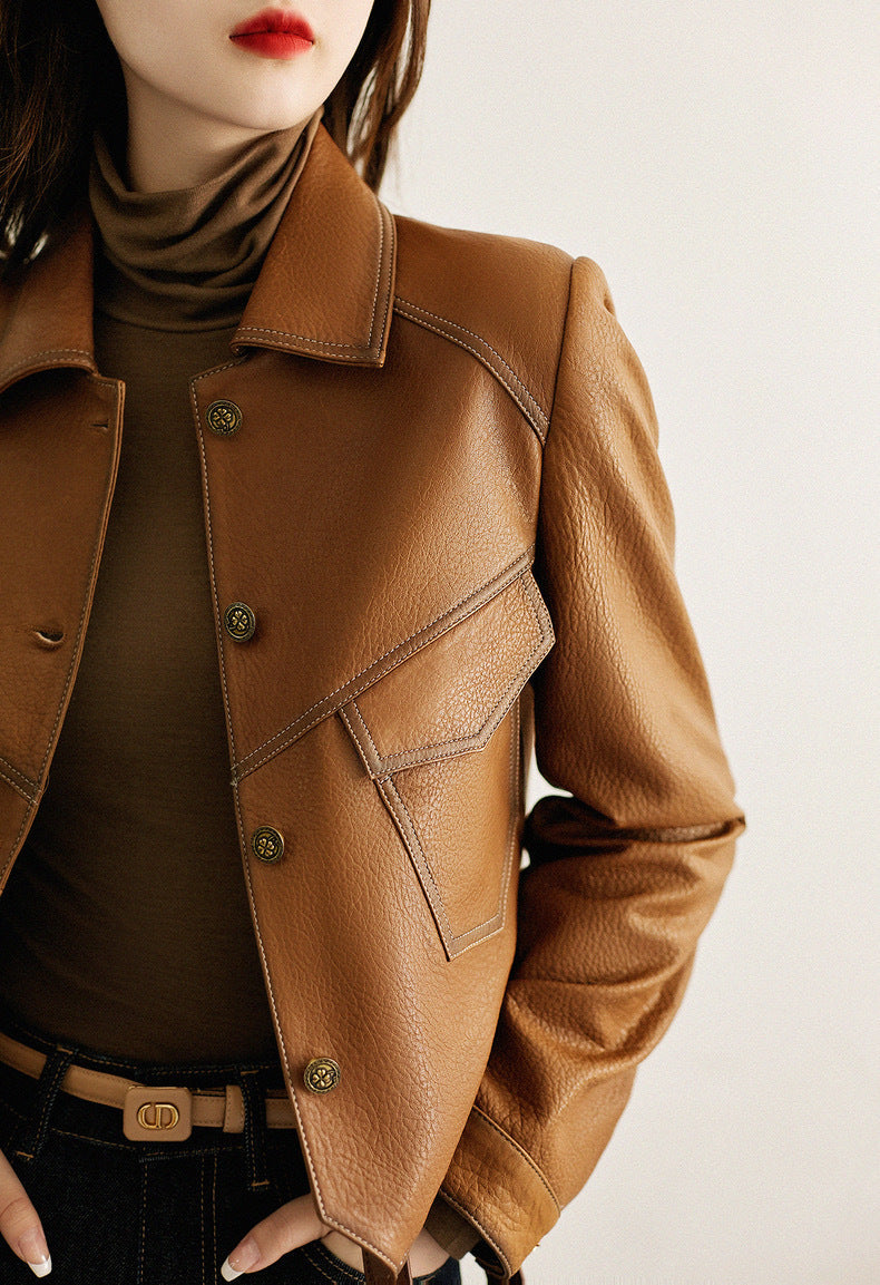 Black women's cropped moto jacket. Sleek biker style outerwear, perfect for an edgy fashion look.