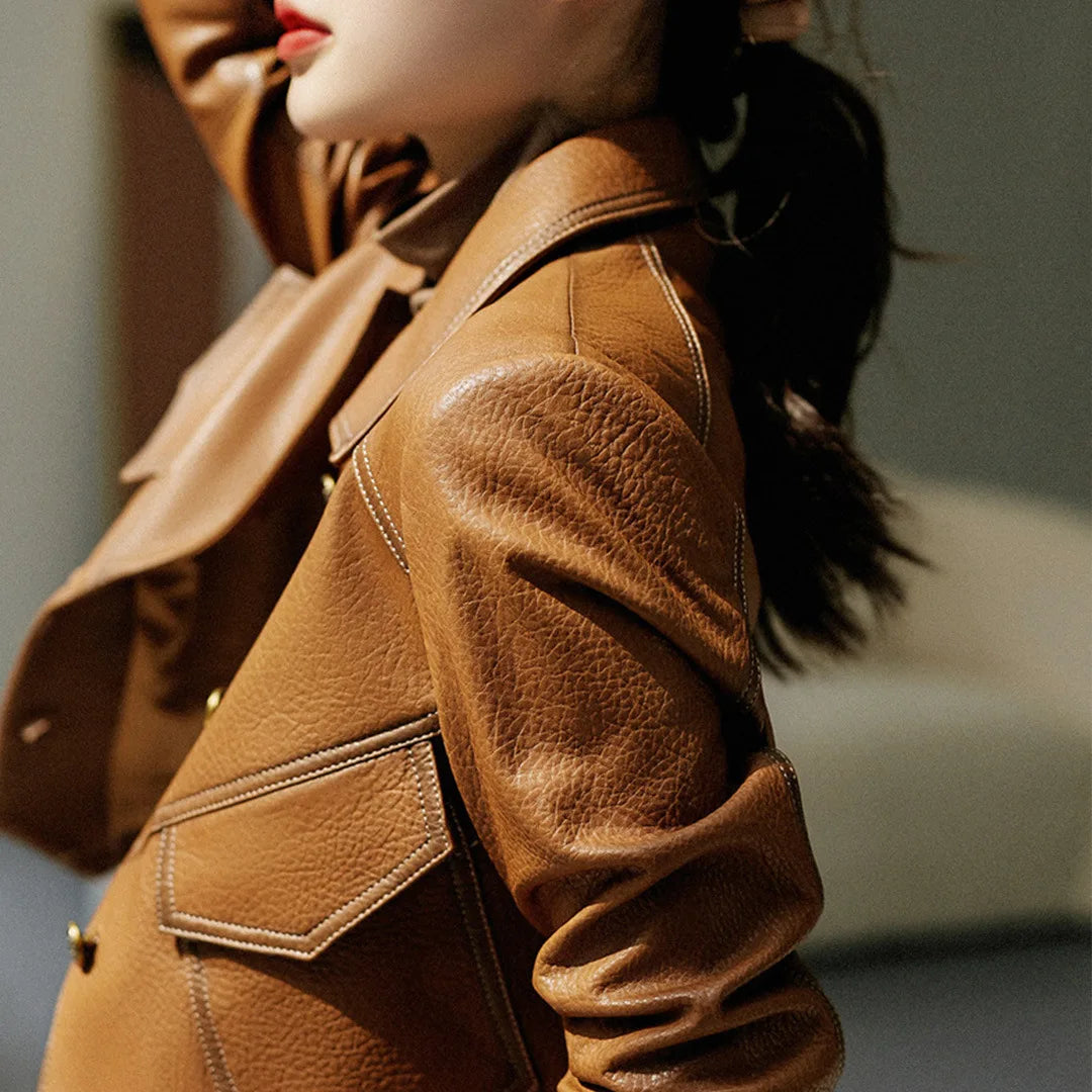 Stylish cropped moto jacket. Detailed view of hardware & lapels on a black women's biker jacket.