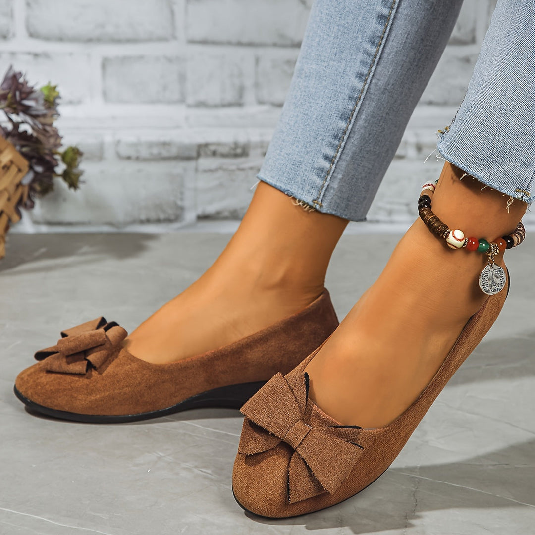 Elegant black women's wedge ballet flats, slip-on, round toe, bow detail, work-ready.