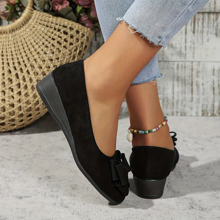 Stylish navy women's slip-on wedge flats, round toe, bow detail, perfect for versatility.