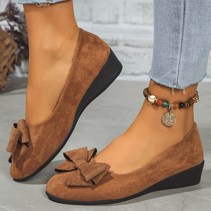 Comfortable women's wedge flats, round toe, slip-on style, with an elegant bow detail.