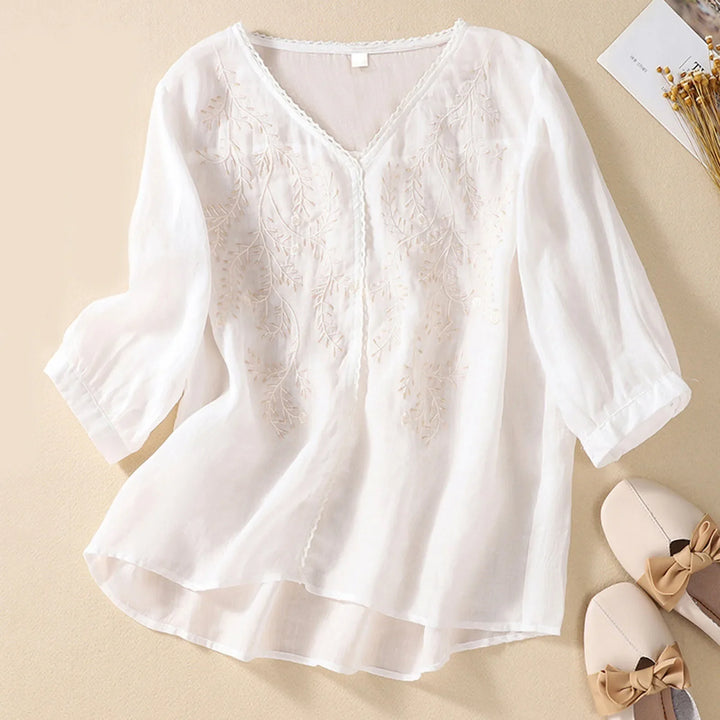 Flowy women's breathable embroidered shirt, an elegant summer top with artistic detail for casual wear.