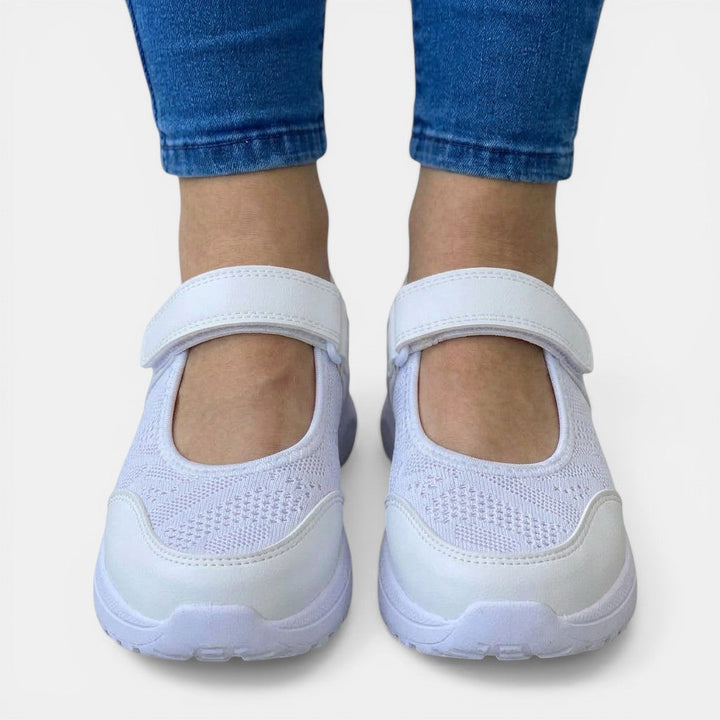 White women's slip-on sneakers with orthopedic support, breathable for casual all-day wear.