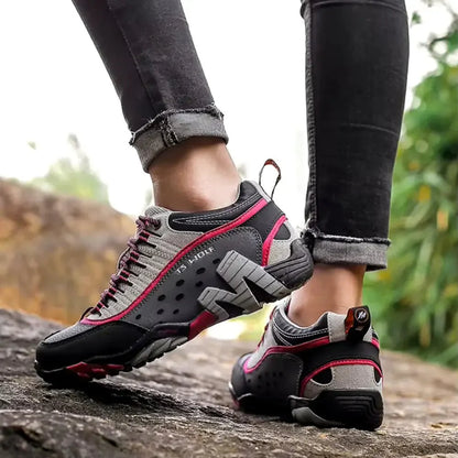 Woman wearing breathable hiking shoes, walking on an outdoor trail for fitness