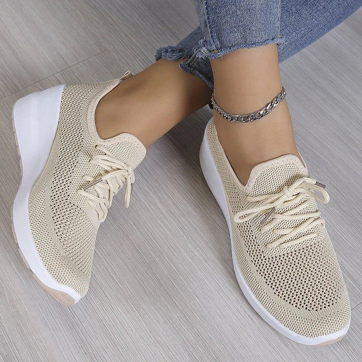 Stylish women's wedge platform sneakers, offering breathable comfort and a trendy athleisure look.