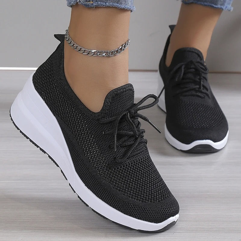 Fashion-forward women's platform wedge sneakers with breathable design for an elevated casual style.