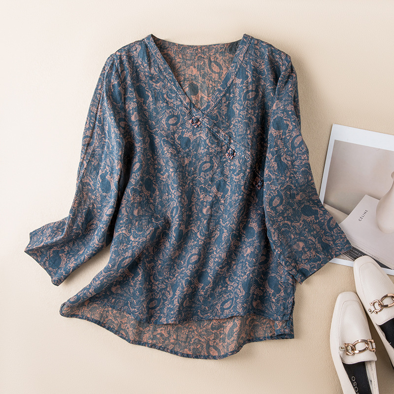 Women's breezy crossover blouse with delicate pattern, perfect for spring/summer casual chic.