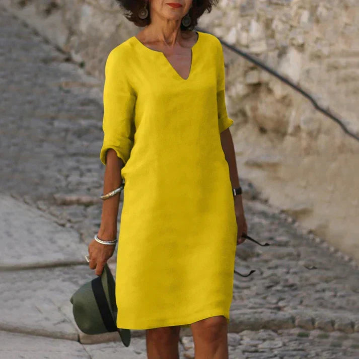 Solid color women's V-neck midi dress, breezy & comfortable for versatile summer wear.