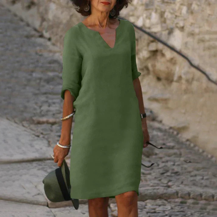 Side view of a women's elegant V-neck midi dress, flowing and breezy for spring & summer.