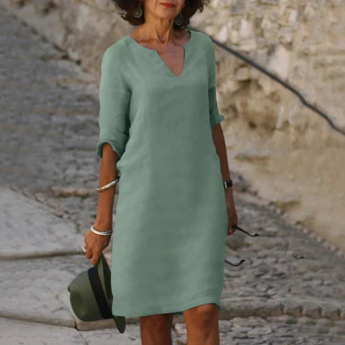 Flat lay of a women's V-neck midi dress, showcasing its sleeveless, comfortable summer design.