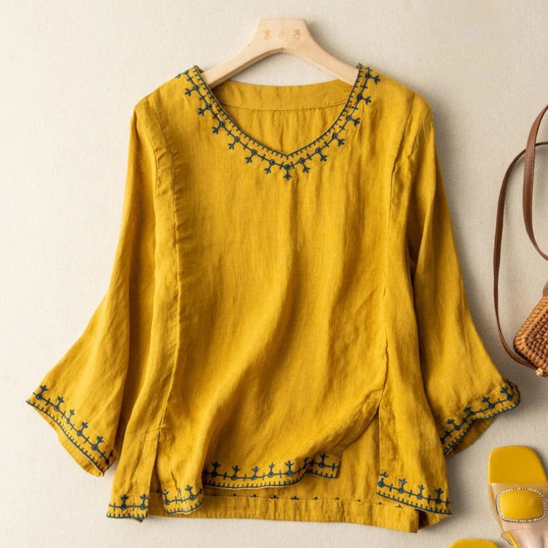 White women's embroidered top with intricate details, ideal for a chic, casual, and relaxed everyday look.
