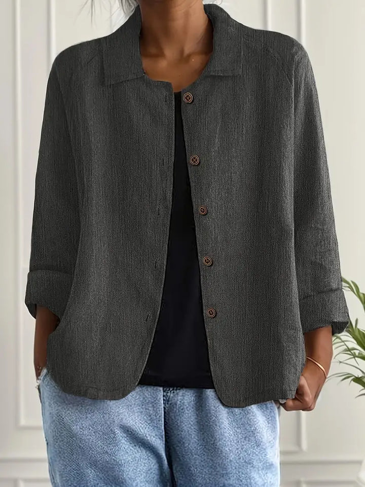 Chic women's collared button-front top, relaxed fit, three-quarter sleeves. Versatile spring/summer fashion.