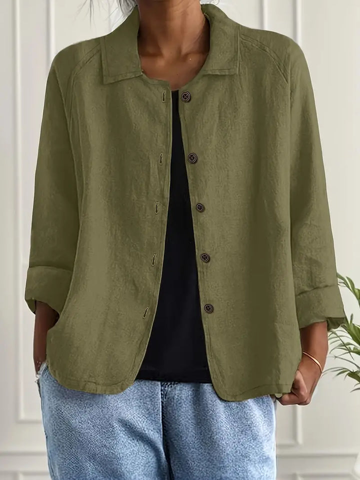 Detail of buttons on a women's relaxed fit casual top. Collared, three-quarter sleeve, versatile fashion.