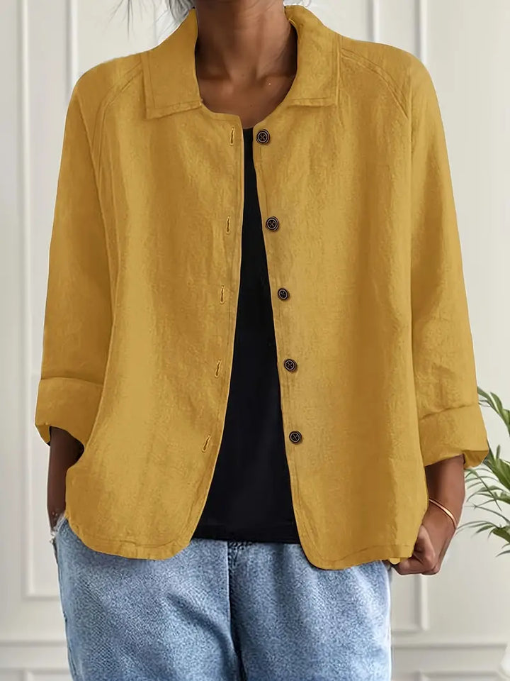 Back view of women's relaxed fit button-front casual top. Three-quarter sleeves, perfect for summer spring.