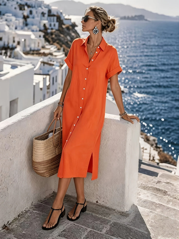 Stylish women's travel-ready shirt dress with short sleeves and button front, a midi length.