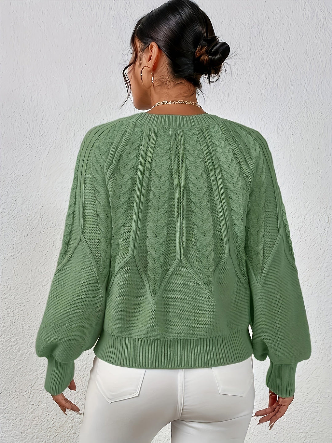 Women's cable knit sweater with relaxed fit & stylish lantern sleeves, perfect for everyday wear.