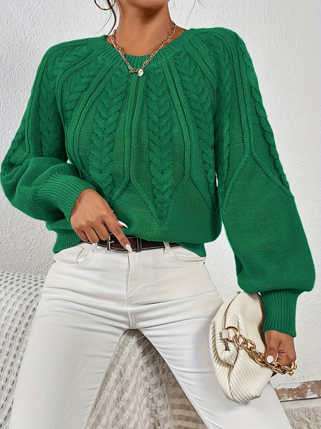 Fall/winter women's cable knit sweater, relaxed fit, statement lantern sleeves for cozy fashion.