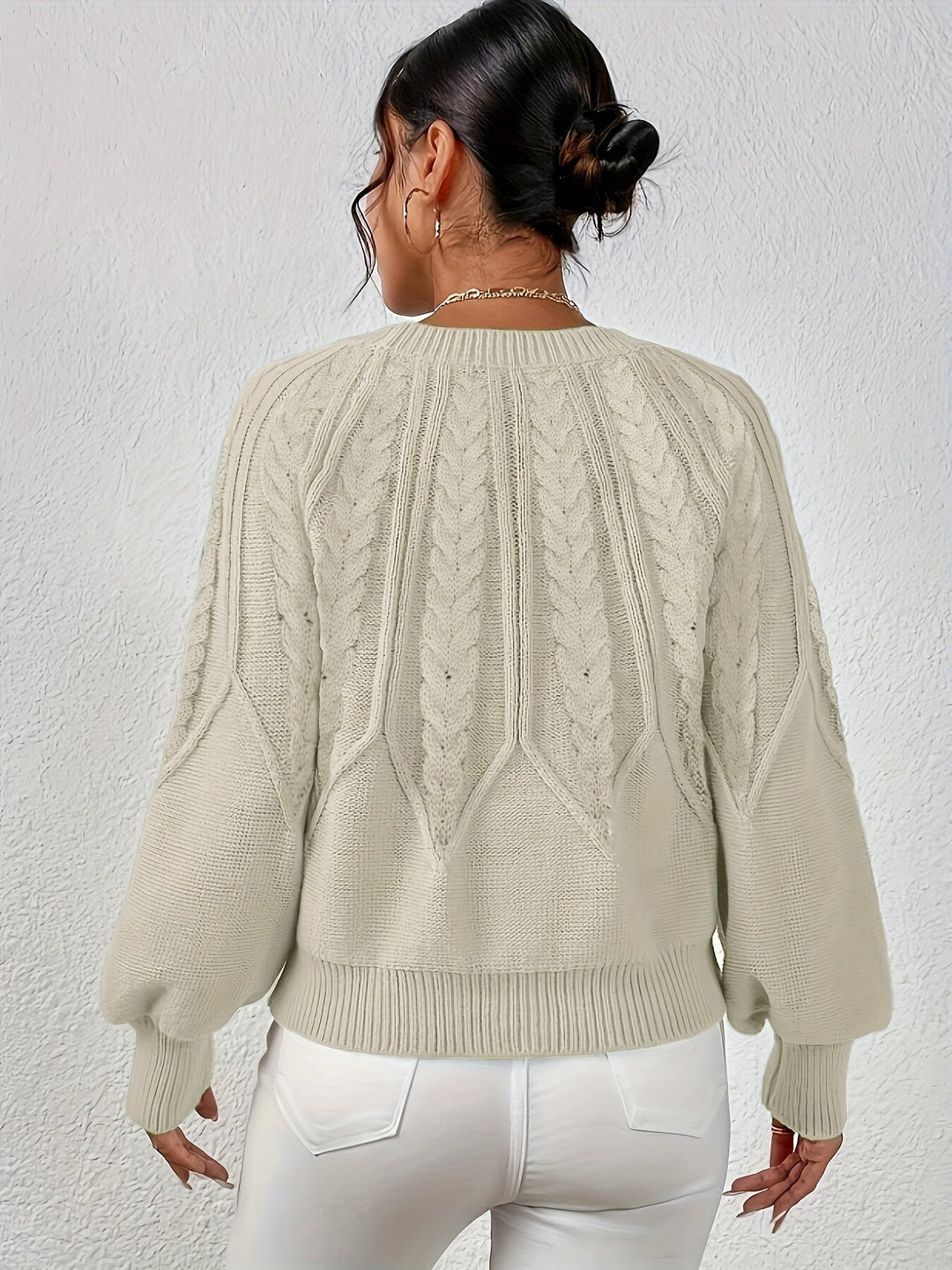 Fall fashion women's cable knit sweater, relaxed silhouette, and statement lantern sleeves.
