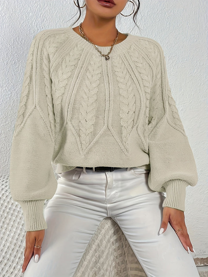 Warm women's cable knit pullover with a comfortable relaxed fit and elegant lantern sleeves.