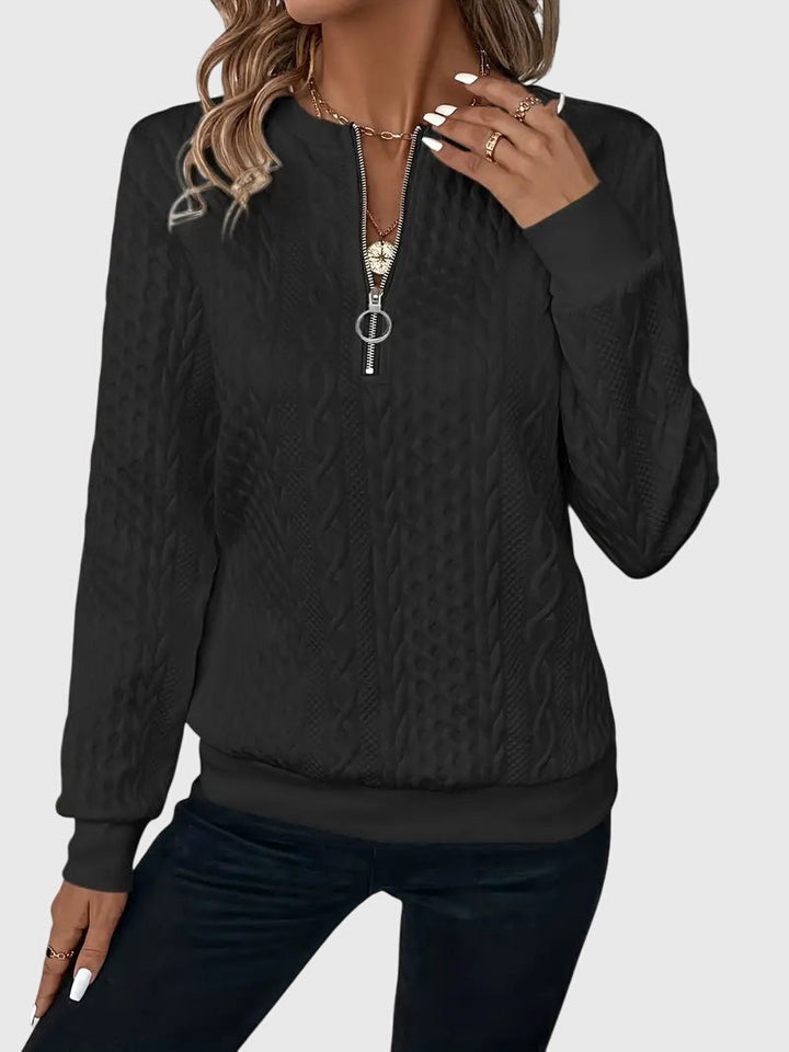 Women's long sleeve cable pattern quarter-zip, perfect for layering.