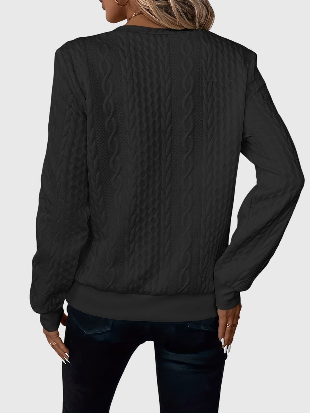 Modern women's cable pattern quarter-zip sweater, textured look.