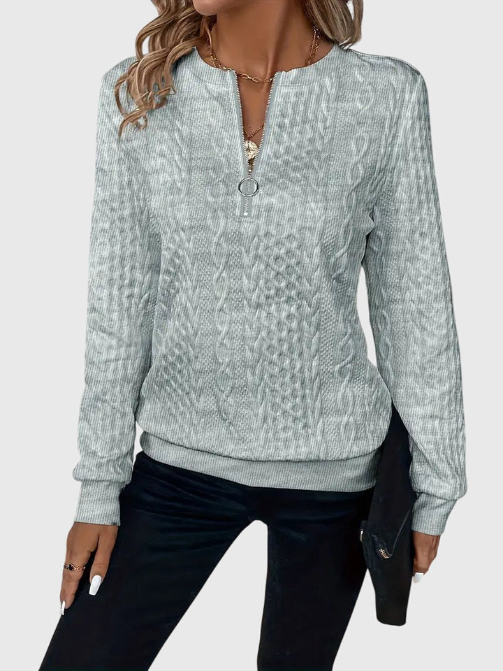 Fashionable women's long sleeve quarter-zip, textured cable pattern.