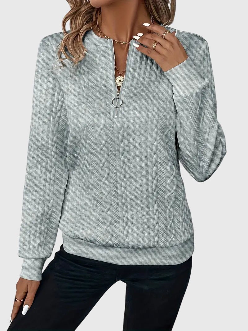 Durable women's cable knit quarter-zip sweater, ideal for daily wear.