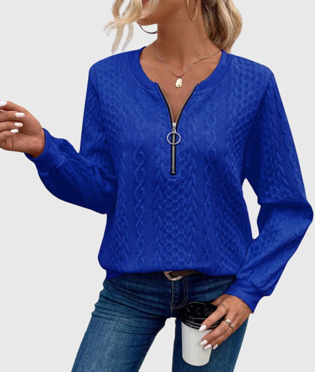 Women's warm quarter-zip sweater, intricate cable pattern, fall essential.