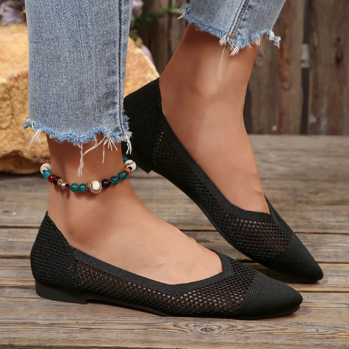 Black Calora women's flats, chic pointed toe design with breathable comfort for versatile wear.