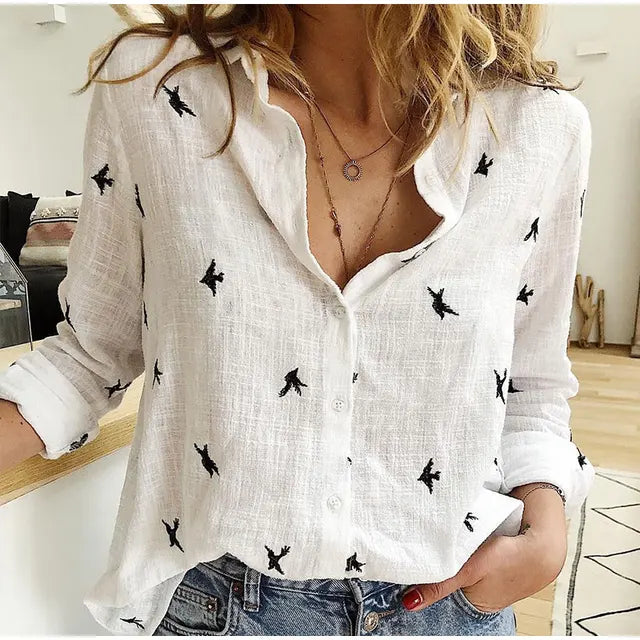Detailed bird print on a women's button-up blouse. Long-sleeve casual top, perfect for a chic everyday look.