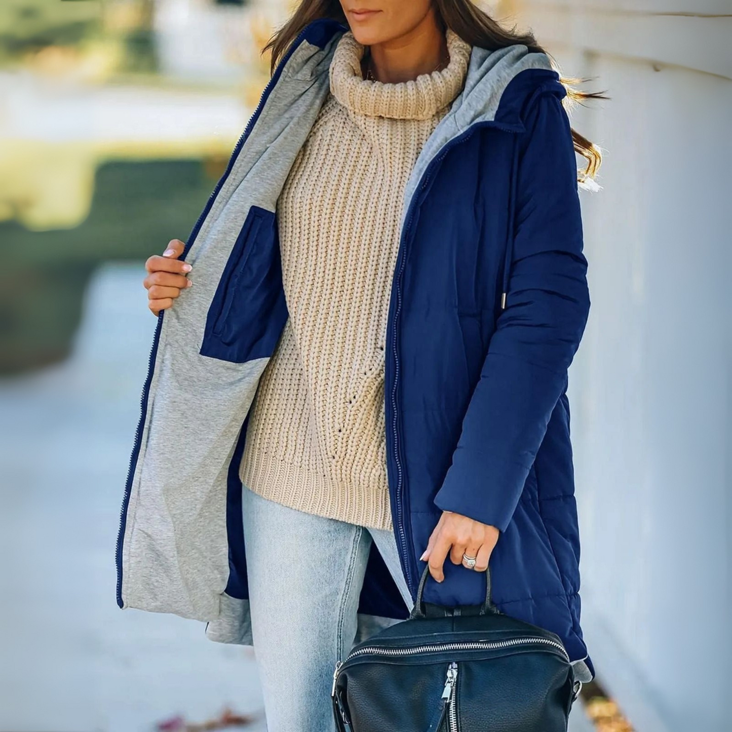 Warm women's puffer jacket with hood for cold weather, a stylish and cozy casual winter coat.