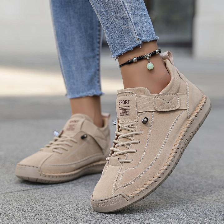 Women's casual lace-up sneakers, white with stitched details, low-top design for everyday comfort.