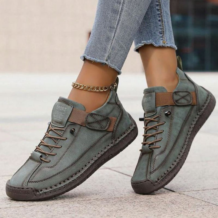 Stylish women's casual lace-up sneakers, comfortable everyday footwear with stitched accents.