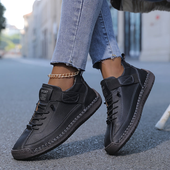 White women's low-top sneakers featuring delicate stitching and practical lace-up closure for casual wear.