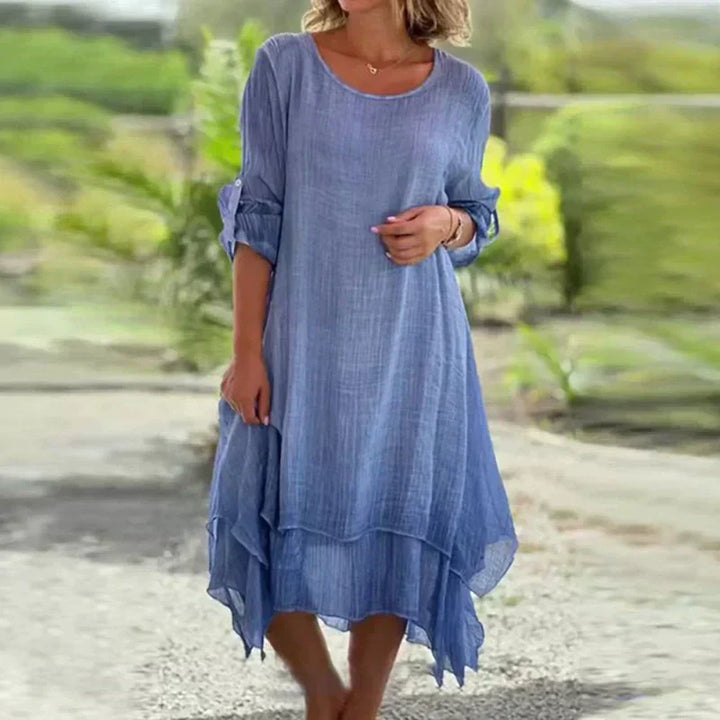 Comfortable women's layered midi dress featuring 3/4 sleeves. Chic, flowy, and relaxed fit for casual summer wear.