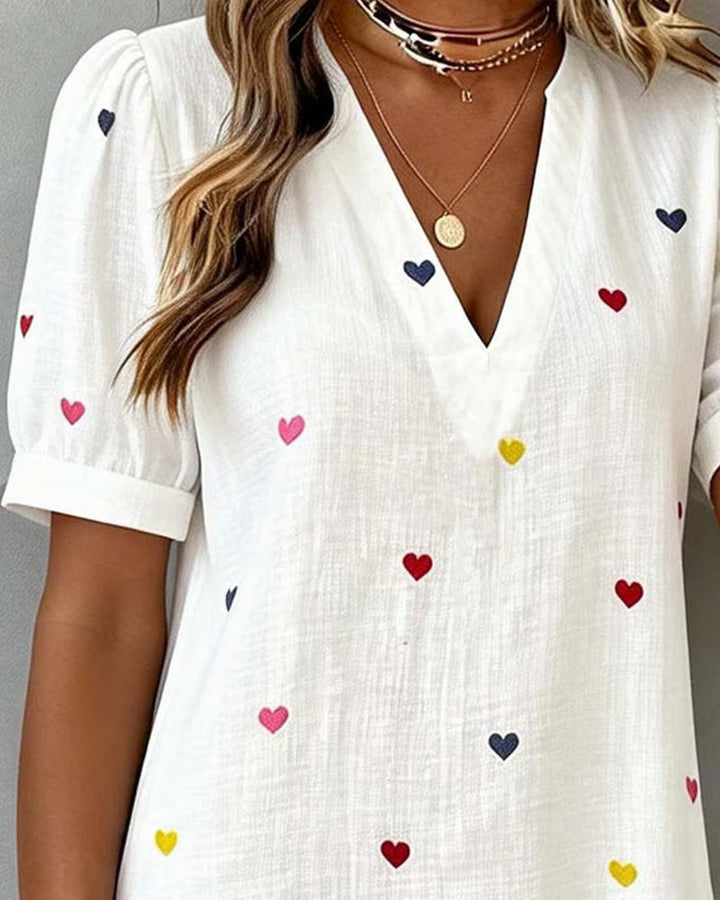 Casual women's mini dress featuring stylish puff sleeves & relaxed fit. V-neck, heart print, great for everyday summer.