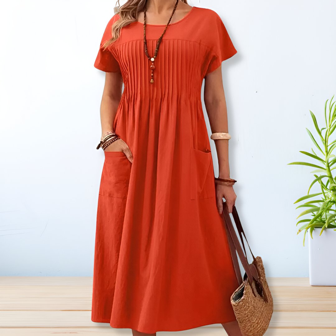 Comfortable women's relaxed midi dress featuring practical pockets, suitable for easy everyday wear.